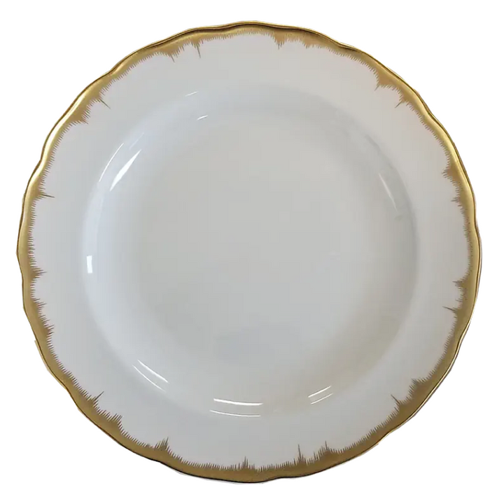 White plate with gold rim on a white background